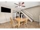 Cozy dining area features a wooden table, ceiling fan, and easy access to other areas of the home at 9028 W Osborn Rd, Phoenix, AZ 85037