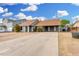 Single-story home with a carport, neutral paint, minimal landscaping, and a concrete driveway at 9028 W Osborn Rd, Phoenix, AZ 85037