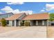 Single-story home with a carport, neutral paint, minimal landscaping, and a concrete driveway at 9028 W Osborn Rd, Phoenix, AZ 85037