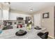 Bright kitchen featuring stainless steel appliances, white cabinets, and a breakfast bar at 9028 W Osborn Rd, Phoenix, AZ 85037