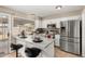 Bright kitchen featuring stainless steel appliances, white cabinets, and a breakfast bar with seating at 9028 W Osborn Rd, Phoenix, AZ 85037