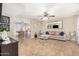 Cozy living room featuring tile flooring, a ceiling fan, and a view into the dining room at 9028 W Osborn Rd, Phoenix, AZ 85037