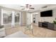 Living room featuring tile flooring, a ceiling fan, and natural light from a large window at 9028 W Osborn Rd, Phoenix, AZ 85037