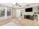 Living room featuring tile flooring, a ceiling fan, and natural light from a large window at 9028 W Osborn Rd, Phoenix, AZ 85037