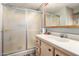 Bathroom featuring a frosted glass door shower and vanity sink with storage cabinets at 9333 E University Dr # 83, Mesa, AZ 85207