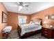 Bedroom featuring a queen sized bed, a ceiling fan, and a side table at 9333 E University Dr # 83, Mesa, AZ 85207