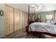 The primary bedroom features a ceiling fan and closet with a sliding wood door at 9333 E University Dr # 83, Mesa, AZ 85207