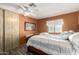 Cozy bedroom with a ceiling fan, warm-toned walls, and sliding door closet at 9333 E University Dr # 83, Mesa, AZ 85207