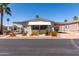 Well-maintained home featuring desert landscaping, awnings, and a covered carport for convenience at 9333 E University Dr # 83, Mesa, AZ 85207