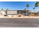 Well-maintained home featuring desert landscaping, awnings, and a covered carport for convenience at 9333 E University Dr # 83, Mesa, AZ 85207