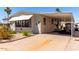 Inviting single-story home with a covered carport, mature landscaping, and a welcoming curb appeal at 9333 E University Dr # 83, Mesa, AZ 85207