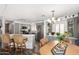Well-lit kitchen with stainless steel appliances, breakfast bar, pendant lighting, and stylish gray cabinetry at 9333 E University Dr # 83, Mesa, AZ 85207