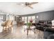 Bright and open living space featuring wood-look flooring, modern furnishings, and a seamless kitchen view at 9333 E University Dr # 83, Mesa, AZ 85207