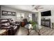 Well-lit living room with comfortable seating, sleek entertainment center, and seamless indoor-outdoor flow at 9333 E University Dr # 83, Mesa, AZ 85207