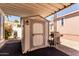 Backyard shed providing extra storage and convenient parking for a golf cart, all under a covered patio at 9333 E University Dr # 83, Mesa, AZ 85207