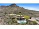 Spectacular aerial view of a modern home with a pool and mountain views in a desert landscape at 11334 E Troon Vista Dr, Scottsdale, AZ 85255