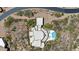 Bird's-eye view showcases the unique architecture, pool, and landscaping of this desert home at 11334 E Troon Vista Dr, Scottsdale, AZ 85255