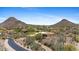 Expansive aerial view of the desert community nestled between two picturesque mountain peaks at 11334 E Troon Vista Dr, Scottsdale, AZ 85255