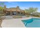 Luxury home features a large covered patio, pool, and desert landscaping at 11334 E Troon Vista Dr, Scottsdale, AZ 85255