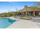 Home's backyard features a spacious deck, swimming pool, and desert views at 11334 E Troon Vista Dr, Scottsdale, AZ 85255