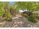 Inviting courtyard with a gravel pathway, mature trees, and comfortable seating area for outdoor relaxation at 11334 E Troon Vista Dr, Scottsdale, AZ 85255