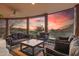 A covered patio featuring plush outdoor seating and stunning sunset views at 11334 E Troon Vista Dr, Scottsdale, AZ 85255