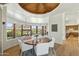 Elegant dining area with a round table, stylish chairs, and scenic views through large windows at 11334 E Troon Vista Dr, Scottsdale, AZ 85255