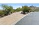 Wide driveway leading to a desert home with beautiful landscaping and mountain views at 11334 E Troon Vista Dr, Scottsdale, AZ 85255