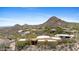 Elevated view of the desert home showcasing architectural details and mountainous landscape at 11334 E Troon Vista Dr, Scottsdale, AZ 85255