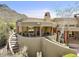 Unique home architecture featuring a winding staircase, second story patio, and desert landscape at 11334 E Troon Vista Dr, Scottsdale, AZ 85255