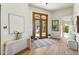 Elegant foyer with wood floors, a console table, and a large glass door providing natural light and style at 11334 E Troon Vista Dr, Scottsdale, AZ 85255