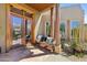 Welcoming front porch with a wooden bench, glass doors, and desert landscaping for a cozy entrance at 11334 E Troon Vista Dr, Scottsdale, AZ 85255