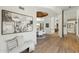 Spacious hallway leading to a dining area, featuring wood floors, art, and natural light at 11334 E Troon Vista Dr, Scottsdale, AZ 85255