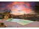 An infinity pool overlooking a scenic landscape with a vibrant sunset at 11334 E Troon Vista Dr, Scottsdale, AZ 85255