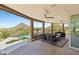 Spacious covered patio with scenic desert views, stylish seating, and a fan for ultimate relaxation at 11334 E Troon Vista Dr, Scottsdale, AZ 85255