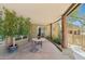 Charming outdoor patio featuring a round table, seating, and natural desert landscaping at 11334 E Troon Vista Dr, Scottsdale, AZ 85255