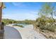 Landscaped backyard features a freeform pool with desert views at 11334 E Troon Vista Dr, Scottsdale, AZ 85255