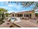 Outdoor kitchen, sparkling pool, covered patio, fire pit, and low-maintenance desert landscaping at 12906 W Oyer Ln, Peoria, AZ 85383
