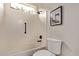 Clean bathroom featuring a shower-tub combo with tiled walls and modern fixtures at 12906 W Oyer Ln, Peoria, AZ 85383