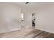 Spacious bedroom featuring wood floors and open doorway to bathroom and office spaces at 12906 W Oyer Ln, Peoria, AZ 85383