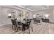 Open-concept dining room with modern gray chairs and views to the open living room at 12906 W Oyer Ln, Peoria, AZ 85383