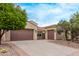Exterior of home featuring a wide driveway and 3-car garage at 12906 W Oyer Ln, Peoria, AZ 85383