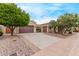 Charming single-story home with a three-car garage, desert landscaping, and a gated courtyard entry at 12906 W Oyer Ln, Peoria, AZ 85383