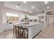 A gourmet kitchen featuring white cabinets, a large island, and seating for entertaining at 12906 W Oyer Ln, Peoria, AZ 85383