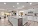 Spacious kitchen with white cabinets, large center island, stainless steel appliances, and open floor plan at 12906 W Oyer Ln, Peoria, AZ 85383