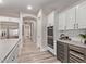 Bright kitchen featuring stainless steel appliances, custom cabinets, wine fridge, and a large island at 12906 W Oyer Ln, Peoria, AZ 85383