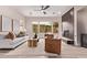 Contemporary living room with eye-catching fireplace, modern furnishings, and a ceiling fan at 12906 W Oyer Ln, Peoria, AZ 85383