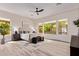 Serene main bedroom with light wood floors, a large window overlooking the backyard, and neutral decor at 12906 W Oyer Ln, Peoria, AZ 85383
