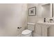 Well-lit powder room with modern fixtures, pedestal sink and elegant decor at 12906 W Oyer Ln, Peoria, AZ 85383