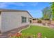 An outdoor kitchen and manicured lawn create a private oasis in this beautifully landscaped backyard at 134 E Bernie Ln, Gilbert, AZ 85295